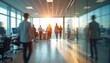 © Maryna - Blurred motion business environment featuring diverse group people walking modern office. Bright sunlight shines through large windows. Corporate professionals, teamwork, innovation, business growth