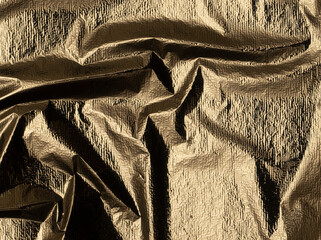 Aufkleber - Golden foil with a shiny, polished sheen. Elegant, reflective fabric with a crumpled texture and beautiful, warm tones. Stylish vertical drapery, showcasing a metallic alloy design with a smooth,.