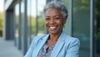© Maryna - Smiling senior black woman in blue business suit outdoors. Confident mature african american businesswoman, entrepreneur. Pro portrait, headshot, executive, ceo. Success career, leadership, smart,