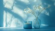 © Agri - Soft blue light illuminates a candle and dried flowers in glass vases.