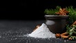 © PACESTOCK - White powdered sugar pile with cinnamon sticks, star anise, and pine branches on a dark slate background.