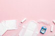 © sosiukin - Ringing alarm clock with sanitary female tampons and menstrual sanitary pads. Medical concept of woman critical days and menstruation. Female daily hygiene. Copy space