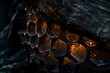 © Starmarpro - Close-up of a honeycomb structure reveals intricate cells with golden reflections, showcasing nature's design in a dark, mysterious setting.