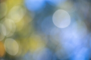 Wall Mural - the image is a blurry blue and yellow background with a few small circles