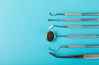 © Avocado_studio - Dentist tools on a blue background. Dentist Concept.Teethcare, dental health concept. Means to care for the oral cavity. Dental model and dental equipment. Dental hygiene. Space for text. Copy space.