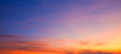 © Prapat - Evening sky background after sundown with dramatic dusk clouds and colorful orange yellow natural light on blue twilight sky, Beautiful summer sunrise panoramic sky backdrop