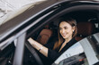 © anatoliycherkas - Businesswoman smiling while driving a new car at the dealership