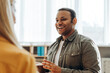 © Maria Vitkovska - Indian businessman holding coffee cup talking with colleague in office
