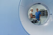© Halfpoint - Doctor explaining CT scan results to patient in hospital setting