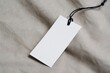 © Ratna - Blank_Paper_Clothing_Tag_on_Beige_Fabric._Simple,_Elegant,_and_Minimalist_Design_for_Retail_and_Fashion_Branding._A_Blank_Label_for_Product_Details.