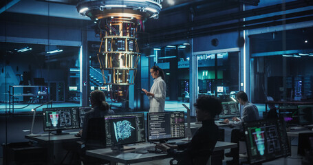 Portrait of a Female Researcher Standing Before a Powerful Quantum Computer, Using a Tablet Computer to Monitor Digital Data. Smart Woman  is Analyzing Results and Parameters Online