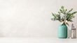 © Giman - A turquoise vase with a bouquet of green foliage on a minimalist white shelf, adorned with a rustic lantern, and serene and elegant home decor concept.