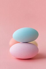 Wall Mural - Pastel colored easter eggs balancing on pink background