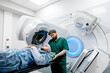 © Vladislav - Modern approaches to oncology treatment. A man undergoes radiation therapy for cancer in a modern oncology clinic using a linear accelerator.