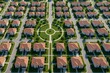 © GenBy - Aerial view of a large suburban neighborhood showcasing rows of identical houses, manicured lawns, and circular pathways, reflecting modern residential architecture and community p