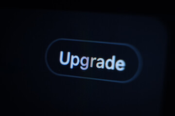 illuminated upgrade button on a dark digital screen