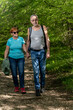 © Nenad - Happy senior couple hiking with backpacks at the beautiful forest. Enjoying nature, having a good time on their retirement