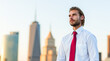 © Minerva Studio - Young businessman looking away in front of New York City skyline