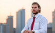 © Minerva Studio - Businessman looking away with Warsaw skyline in background at sunset