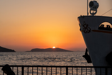 Fototapete - Sunset over Prince Islands with silhouette of a boat in calm waters