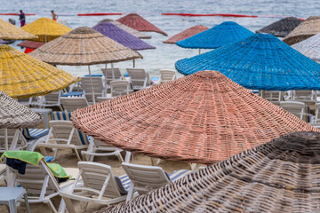 Leinwandbilder - Colorful umbrellas lined up at the beach on Prince Islands during a sunny day