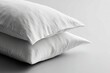 © BYAI - Soft white pillows stacked on a clean, minimalistic surface in a bright, airy space for a cozy atmosphere