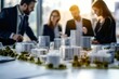 © maxcity - A team collaborates around a city model in a modern office, planning a new real estate project.
