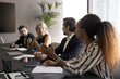 © fizkes - Share insight. Interested diverse polyethnic business team stakeholders coworkers gather on brainstorm department briefing training conference listen to young Black lady proposing plan idea to discuss