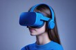 © Anjali - Young woman wearing blue VR headset and headphones, immersed in virtual reality experience.