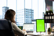 © DC Studio - General director working in her own office with green screen, looking at device display and developing a new project idea. Female entrepreneur empowered by corporate culture.