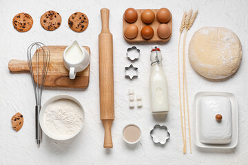 Wall Mural - composition with wooden rolling pin and ingredients for dough on white background