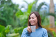 © Farknot Architect - Portrait image of a woman drinking coffee and relaxing in the garden