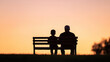 © mangolovemom - father and son sit on bench silhouetted against vibrant sunset sky, creating serene and touching moment of connection and reflection