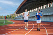 © bongkarn - Two asian men are jogging or running together on the racetrack in sports stadium. Outdoor exercise.