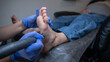 © Михаил Решетников - Pregnant woman on a hardware pedicure procedure in a beauty salon.