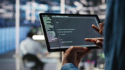 Close up of server room programmer checking coding on tablet enhancing operational efficiency and reducing downtime. Developer verifying programming language script used to update gear, camera A