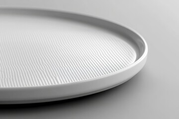 Leinwandbilder - White textured plate placed on a smooth surface highlighting minimalism and design aesthetics in a modern kitchen setting