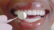 © Georgy - A patient is shown in close-up while undergoing a dental examination, highlighting their healthy teeth and the professionalism of the care they are receiving