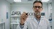 © talkative.studio - Scientist writing DATA SCIENCE on glass panel