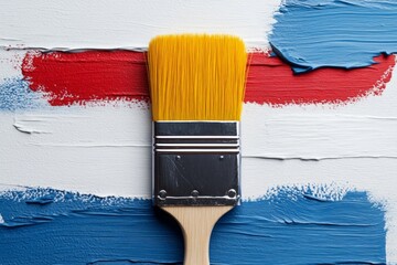 Aufkleber - Bright brush with yellow bristles smearing red and blue paint on white surface during creative art project