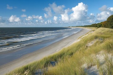 Aufkleber - Coastal landscape with gentle waves and sandy beach under a vibrant sky near the shoreline
