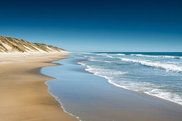 Aufkleber - Serene coastal view at low tide with gentle waves and sandy shore