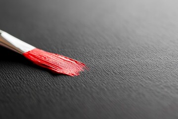 Aufkleber - A vivid red brushstroke is applied to a textured black canvas, illustrating the bold artistry and inviting tactile detail, with copy space on the left side