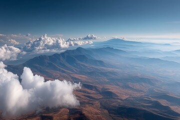 Poster - Majestic mountains with clouds above a serene landscape during early morning light