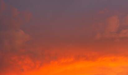 Fototapete - Dramatic sunset sky clouds background in the evening with red, orange, yellow and pink sunlight on golden hour after sundown, Romantic sky in summer on dusk