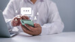 © Thawatchai Images - Businessman hand using smartphone typing Live chat chatting and social network concepts, Social media marketing technology concept, Chatting conversation working at home in chat box icons pop up.