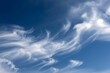 © Татьяна Евдокимова - Wispy cirrus clouds create a mesmerizing display against a vibrant blue sky, resembling brushstrokes on a canvas