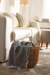 Poster - Wicker basket with gray blanket in living room