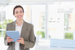 © WavebreakMediaMicro - Woman holding light blue tablet in modern bright office, with natural light theme, copy space