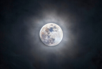 Wall Mural - Full moon among the clouds. Full moon photographed with a telescope.